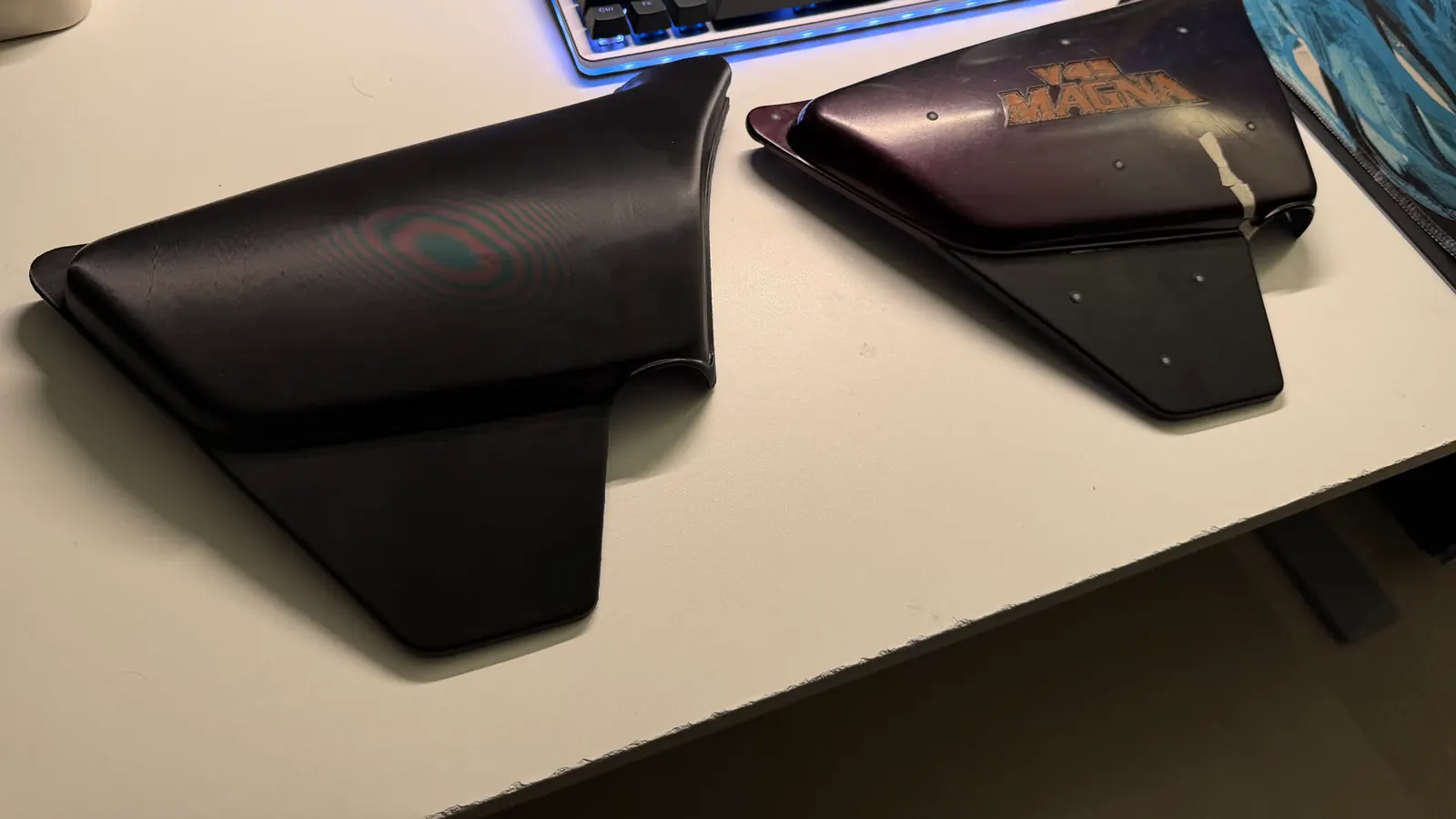 Printed Magna battery door (left) beside the original Honda cover